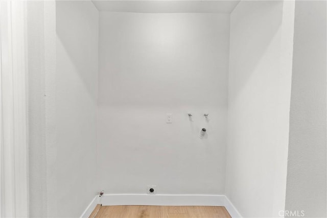 laundry area with washer hookup, light wood finished floors, electric dryer hookup, laundry area, and baseboards