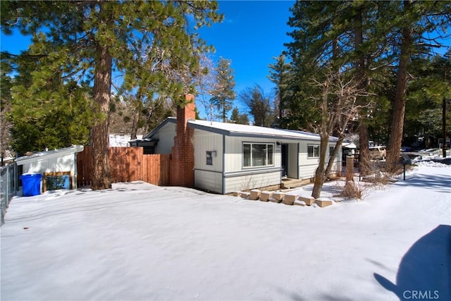 manufactured / mobile home with fence and a chimney