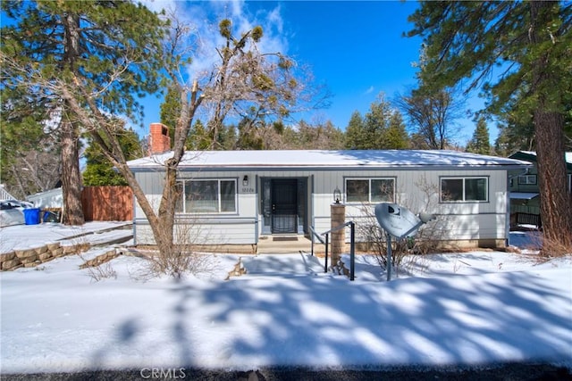 ranch-style home with fence