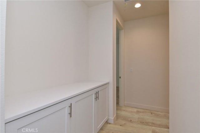 hall featuring recessed lighting, light wood-style flooring, and baseboards