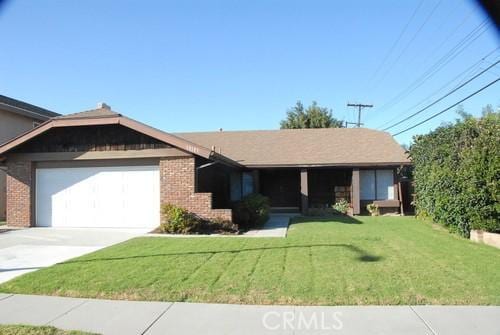 single story home with brick siding, driveway, an attached garage, and a front lawn