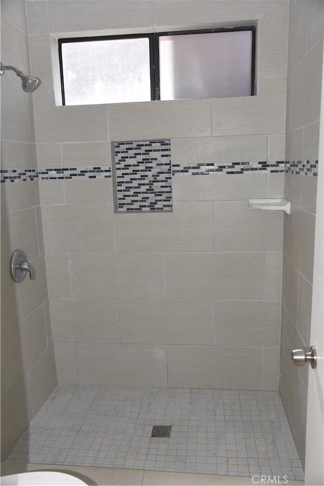 bathroom with tiled shower