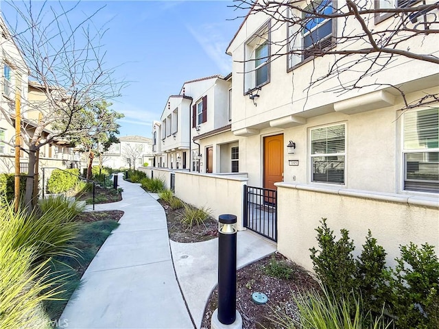 view of property's community featuring a fenced front yard and a residential view