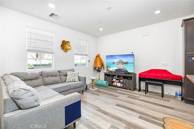 living room with recessed lighting, visible vents, and light wood-style flooring