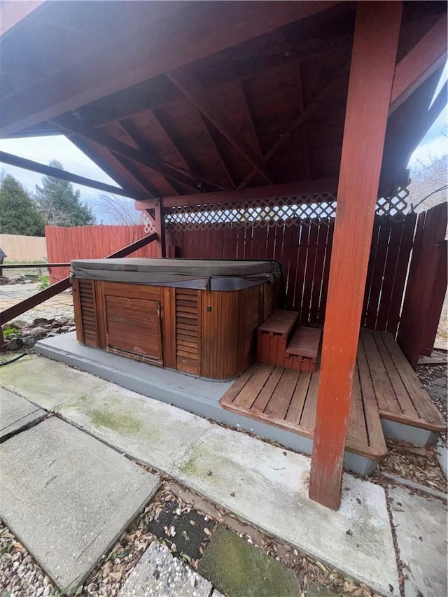 deck with fence and a hot tub