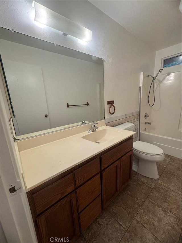 bathroom featuring toilet, shower / washtub combination, tile walls, and vanity