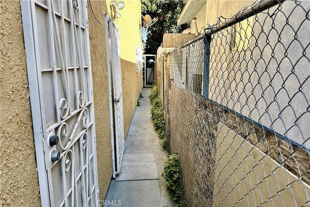 exterior space featuring fence and stucco siding