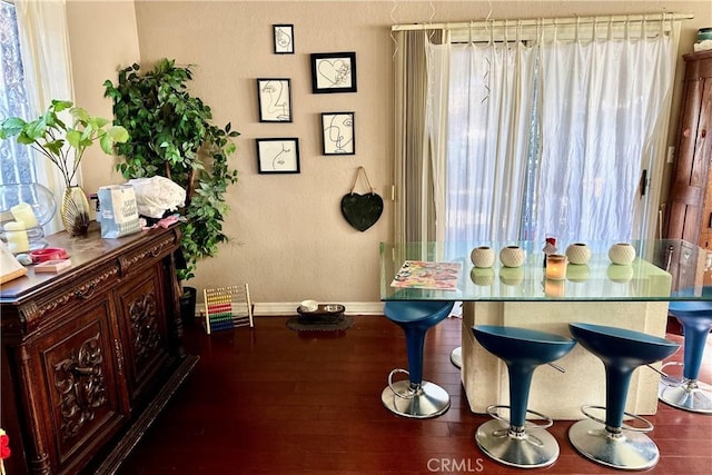 dining area featuring plenty of natural light, baseboards, and wood finished floors