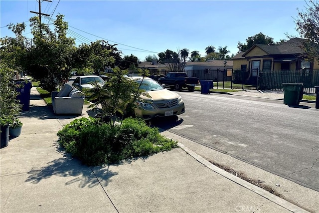 view of street with sidewalks, a residential view, and curbs