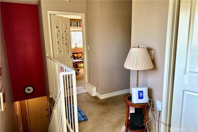 hallway with carpet flooring and baseboards