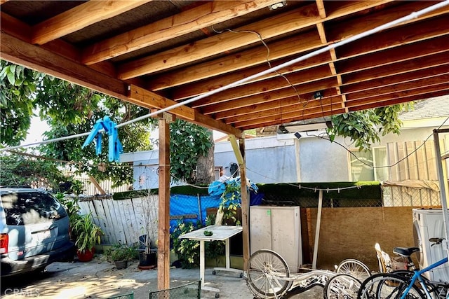 view of patio / terrace with washer / clothes dryer and fence