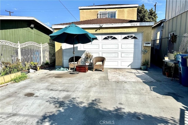 exterior space featuring concrete driveway and fence