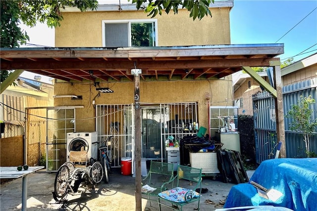 exterior space featuring washer / clothes dryer and fence