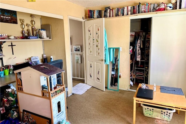 bedroom with a closet, carpet flooring, and a textured ceiling