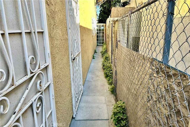 view of home's exterior with fence and stucco siding