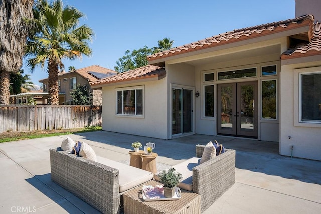 view of patio featuring french doors, an outdoor hangout area, and fence