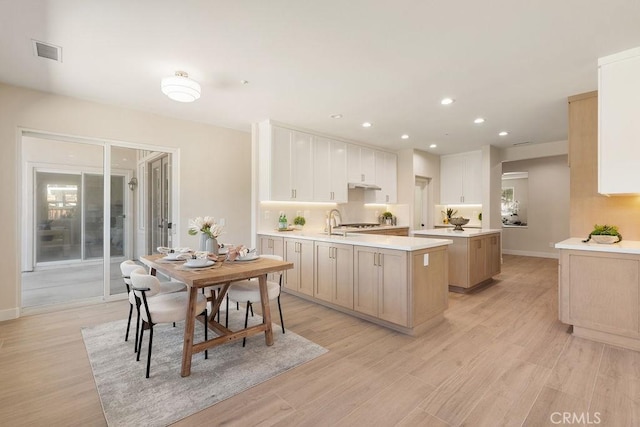 kitchen featuring tasteful backsplash, visible vents, light countertops, light wood-type flooring, and recessed lighting