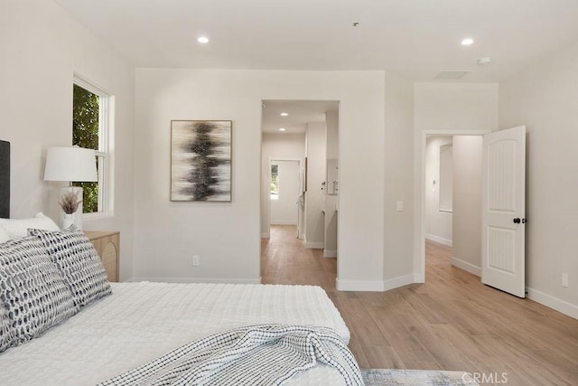 bedroom featuring recessed lighting, light wood-type flooring, and baseboards