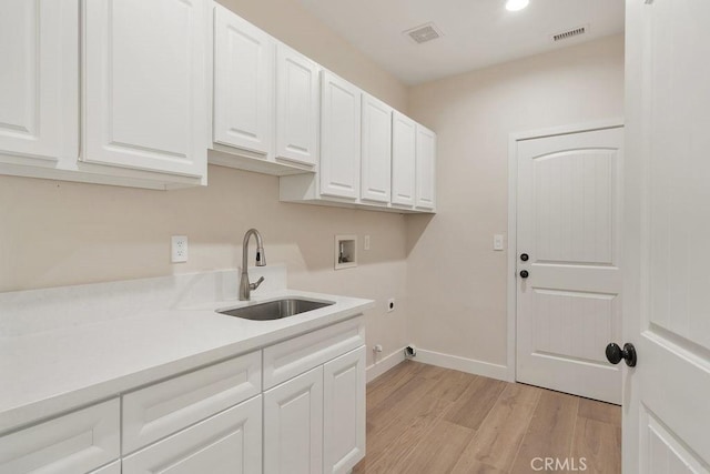 laundry room with visible vents, a sink, cabinet space, hookup for an electric dryer, and hookup for a washing machine