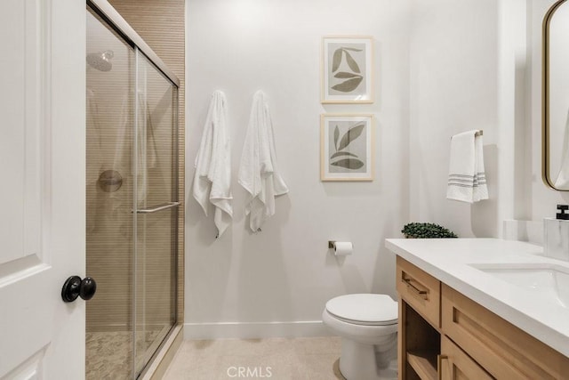 full bathroom featuring baseboards, toilet, a stall shower, tile patterned floors, and vanity