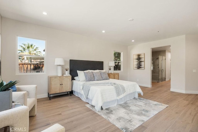 bedroom featuring light wood-type flooring, multiple windows, and baseboards