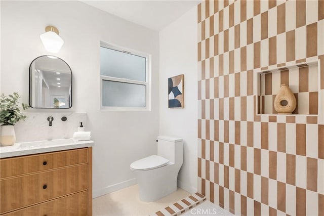 bathroom featuring tasteful backsplash, vanity, and toilet