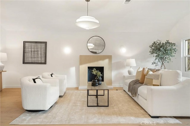 living room featuring light wood-type flooring and baseboards