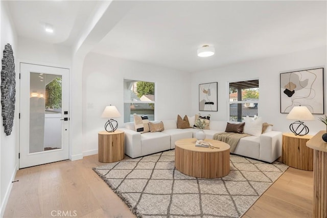 living room featuring light wood-type flooring and baseboards