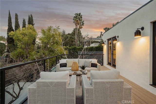 balcony at dusk with outdoor lounge area