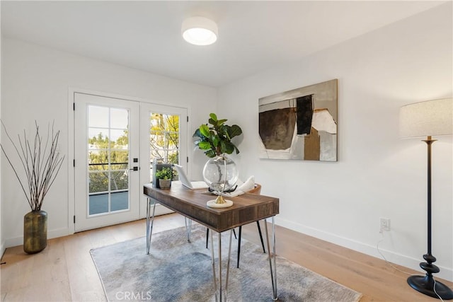 office space featuring french doors, wood finished floors, and baseboards