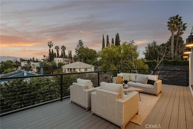 deck at dusk featuring an outdoor living space