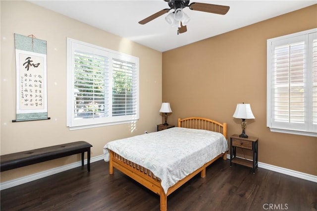 bedroom with wood finished floors, a ceiling fan, and baseboards