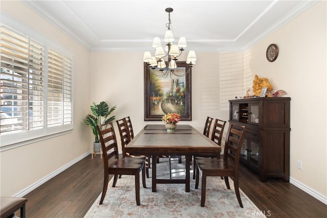 dining space featuring baseboards, crown molding, wood finished floors, and a notable chandelier