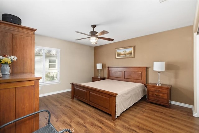 bedroom featuring baseboards, ceiling fan, and light wood finished floors