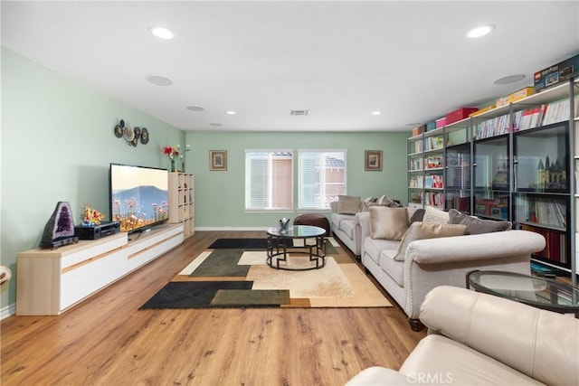 living room featuring recessed lighting, visible vents, baseboards, and wood finished floors