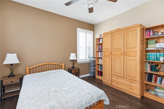 bedroom with a ceiling fan, baseboards, and dark wood-style flooring