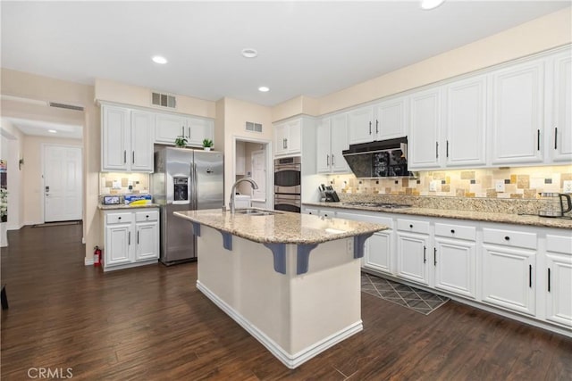 kitchen with stainless steel appliances, a sink, visible vents, and white cabinetry