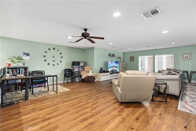 living area with ceiling fan, recessed lighting, visible vents, and light wood-style floors