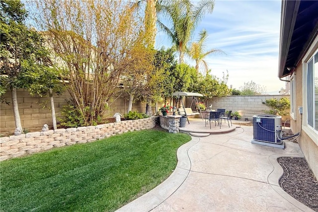 view of yard with a fenced backyard, a patio, and central air condition unit