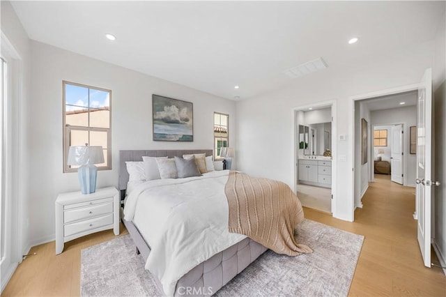 bedroom featuring light wood-style floors, recessed lighting, visible vents, and baseboards