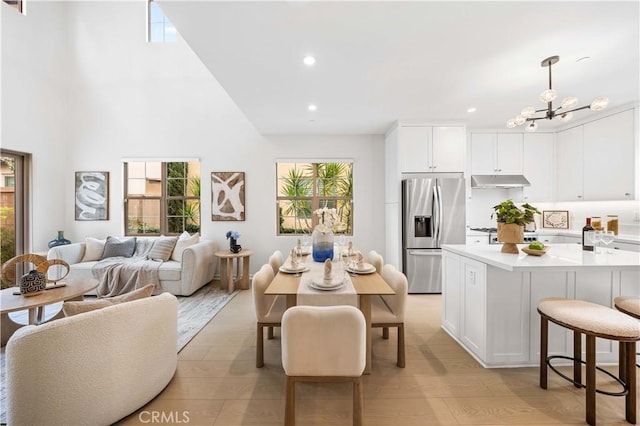 dining area featuring a chandelier, light wood finished floors, and plenty of natural light