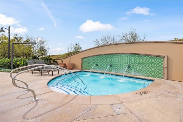 view of swimming pool featuring a community hot tub and a patio