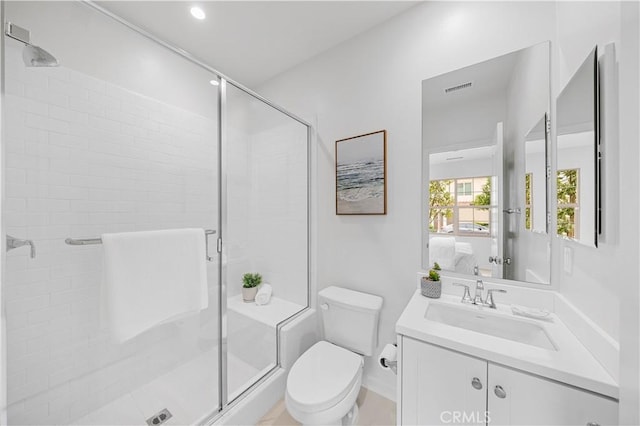 full bathroom featuring visible vents, toilet, a shower stall, and vanity