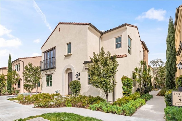 mediterranean / spanish-style home featuring a tiled roof and stucco siding