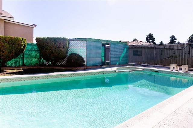 view of swimming pool featuring fence and a fenced in pool