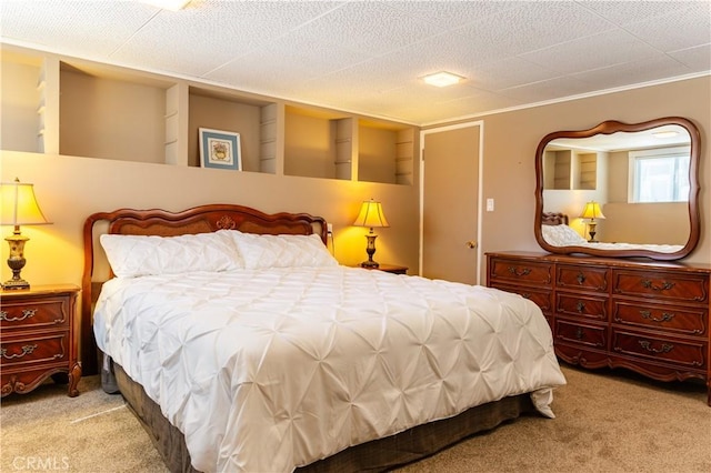 bedroom with light carpet and a textured ceiling