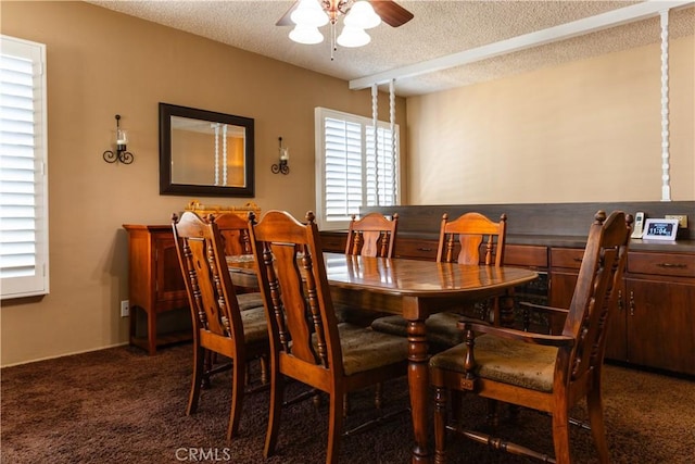 carpeted dining room featuring a textured ceiling and ceiling fan