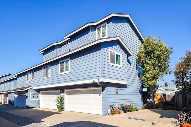 view of front of home with a garage and fence