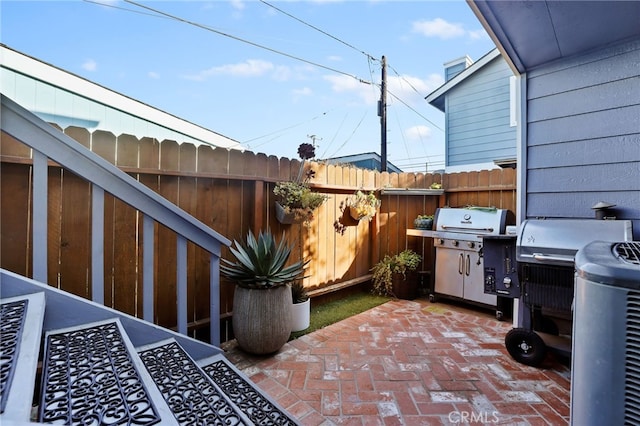 view of patio / terrace featuring area for grilling and fence