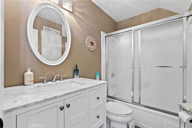 full bath with toilet, enclosed tub / shower combo, vaulted ceiling, and vanity